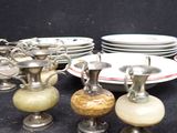 a lot of dishes and cups sitting on a table