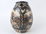 a vase that has a picture of a tree on it