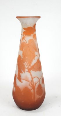 an orange vase with white flowers on it on a white background
