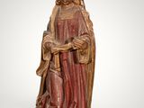 an old statue of a woman holding a baby in her arms