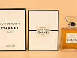 a close up of a bottle of perfume next to a box