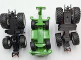 two toy tractors that are sitting next to each other