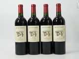three bottles of red wine sitting next to each other on a white surface
