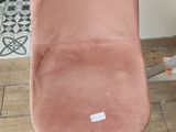 a pink chair that is sitting on the floor