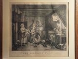 an old picture of a family in a kitchen with a dog