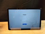 a laptop with a cracked screen sitting on a table
