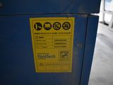 a yellow sign on the side of a blue machine