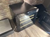 a metal cabinet with four drawers in front of a brick wall