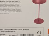 packaging of a pink lamp on a table in a store
