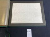 an open book with writing on it sitting on a table