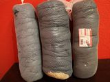 three pieces of fabric wrapped in a mesh bag on a table