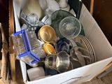 a box full of dishes and utensils sitting on the floor
