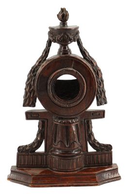 une horloge en bois surmontée d'un oiseau