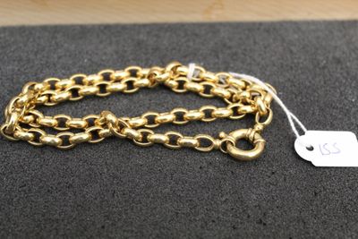 a close up of a gold chain bracelet with a tag on it