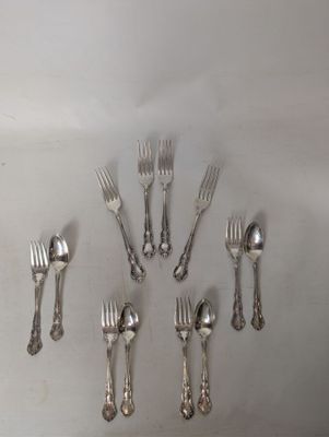 a lot of forks and spoons arranged in a circle