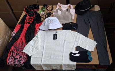 a lot of clothes and a hat on a table