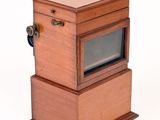 a small wooden box with a television inside of it