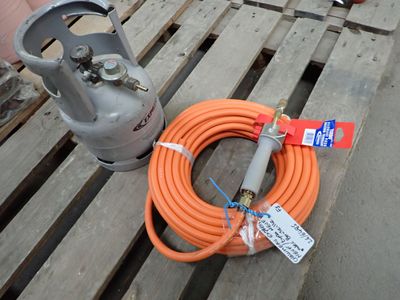an orange hose and a propanene on a pallet
