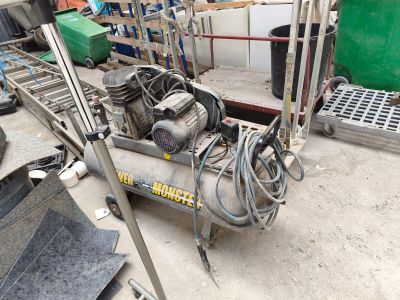 an image of a small air compressor in a garage