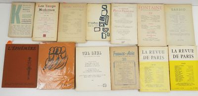 several books are lined up on a white surface