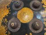 a large black and gold vase sitting on a table
