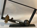 a mirror with a statue of a man and a dog on it