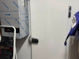a white refrigerator in a room with a lot of clutter
