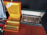 a box of silverware on a table with other silverware in it