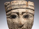 a close up of a clay head of a person wearing a hat