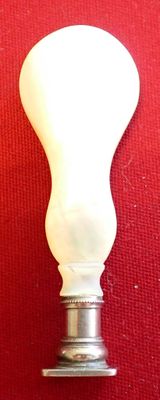 a white light bulb that is on a red surface