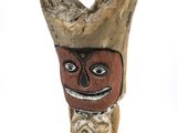 a wooden figurine of a man with a hat on