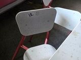 a white table and two chairs in a room