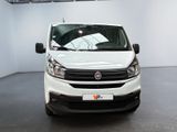 the white van is parked in a large room with a black floor
