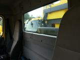 two seats in the back of a truck with a view of a construction truck through the window