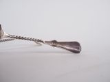 a silver spoon and a fork on a white surface