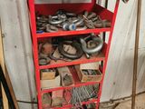 une étagère rouge remplie de nombreux outils dans un garage