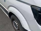 a white van that is parked on the side of the road