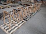 many pieces of wood sitting on pallets in a warehouse