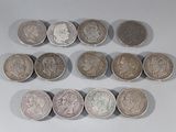 several different types of coins are arranged in a row on a white surface