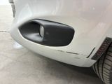 a close up of a white car with a black door handle