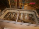 a glass display case with several pans inside of it