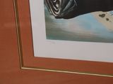 a picture of a picture of a black cat laying on a bed