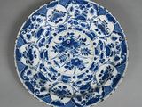 a blue and white plate with a floral design on it