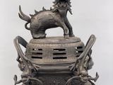 a statue of a dog on top of a vase