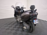 a motorcycle that is parked in a room with a checkered floor