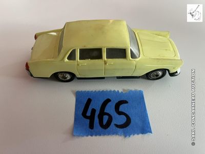 une petite voiture posée à côté d'une feuille de papier