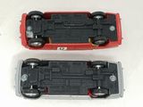 two toy cars sitting side by side on a white surface