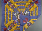 a blue silk scarf with gold and red tassels on it
