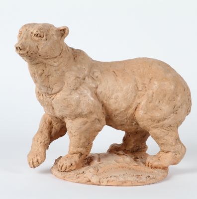sculpture of a bear on a rock on a white background