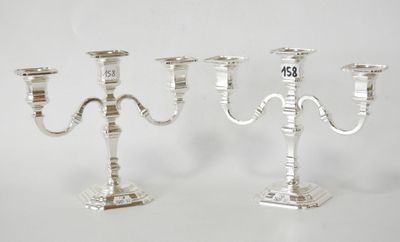 two silver candelabs with numbers on each of them